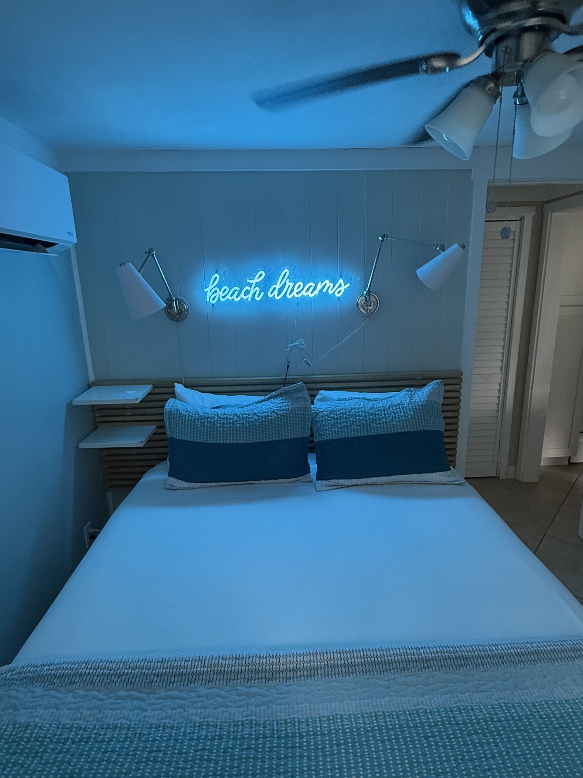 Cozy Beach Bungalow bedroom with beach dreams neon sign